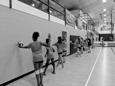 Group of girls using wall for hitting drill