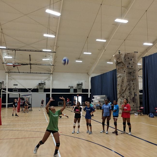 Young Girls learning how to volleyball set