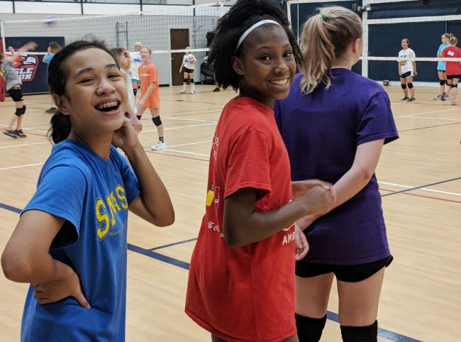 Students smiling during volleyball practice