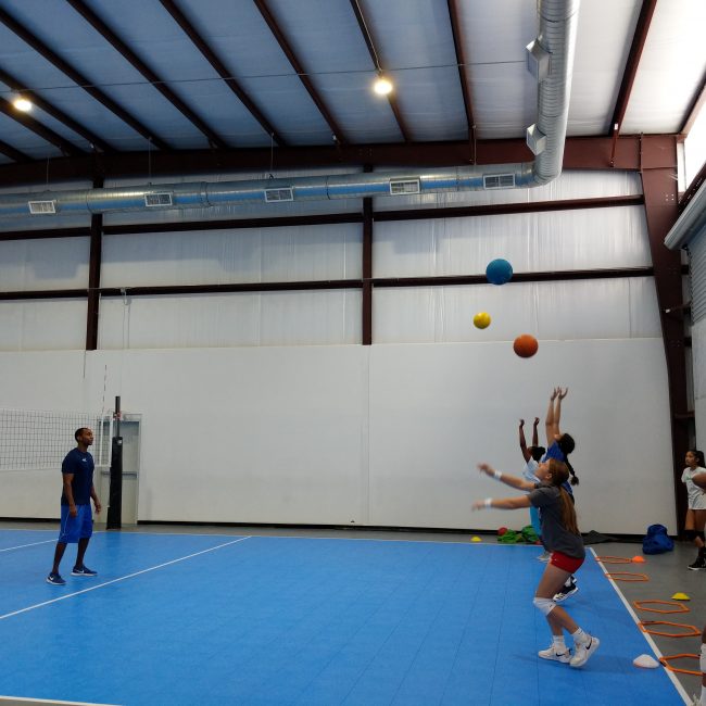 Group of girls tossing volleyball