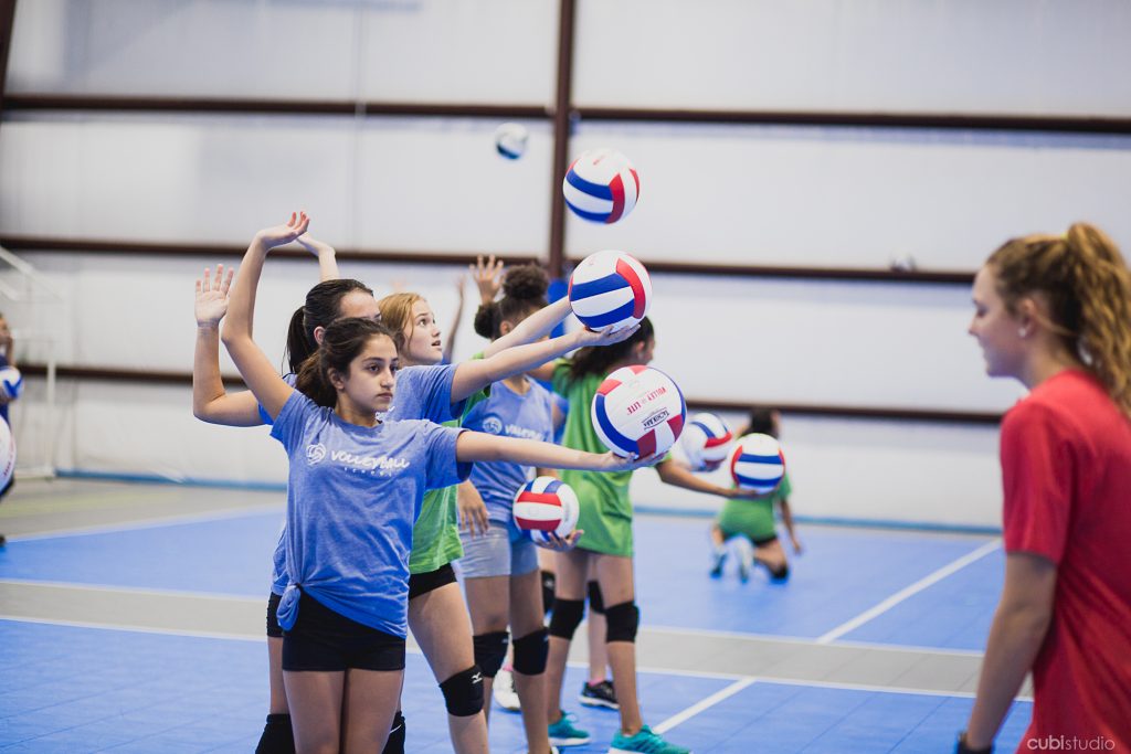 group of girls practicing hitting a volleyball