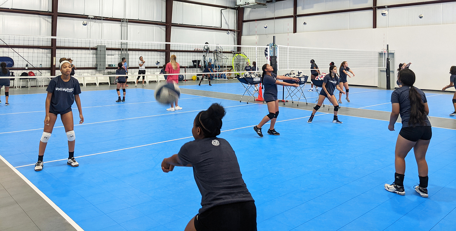 Group of girls training volleyball at the volleyball school